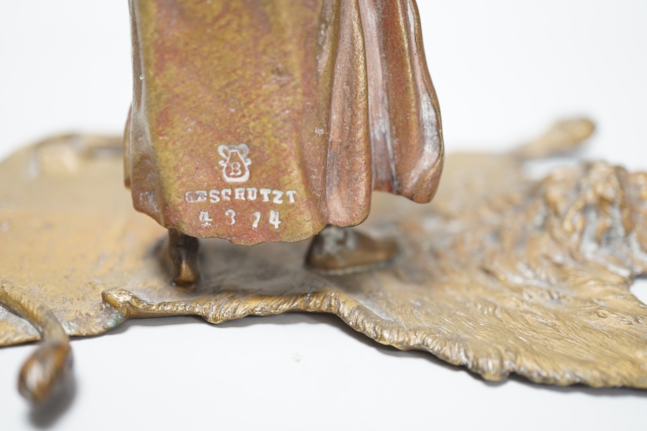 An Austrian cold painted bronze model of a Bedouin trader, depicted holding an Ibex head, standing on a lion skin, after Franz Bergman. 12cm tall